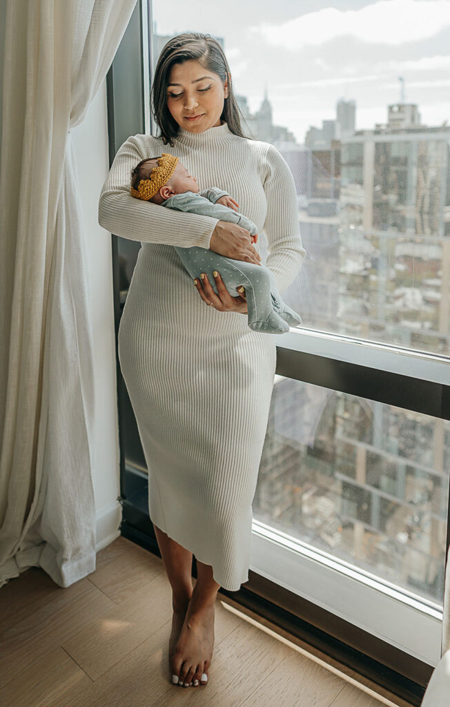 NYC in home family newborn session, mom holding her newborn son.